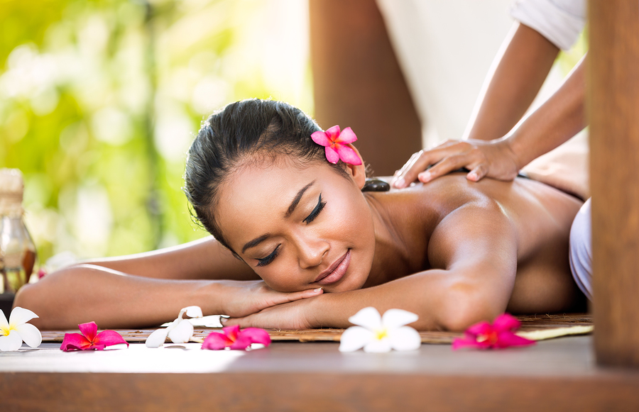 Woman having relaxing Asian massage in spa salon